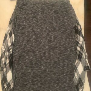 I am selling a cute grey black and white skirt with a plaid designed back